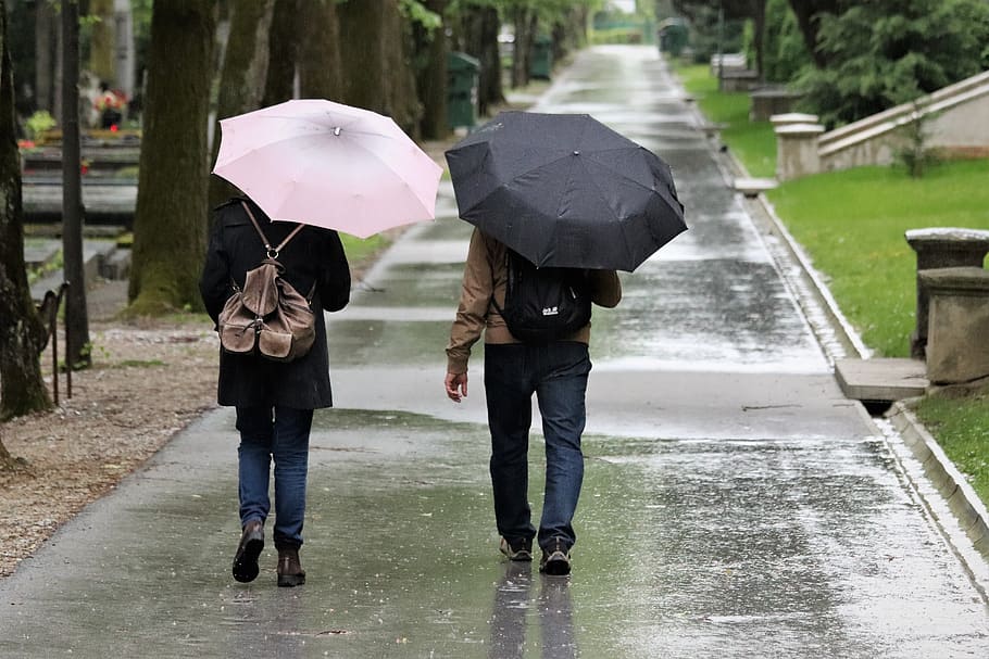 rain-tourists-walking-umbrella-walk-road-evening